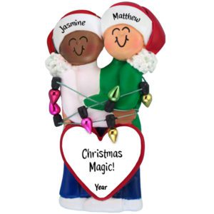 Image of African American Female Caucasian Male Couple Tangled In Lights Ornament